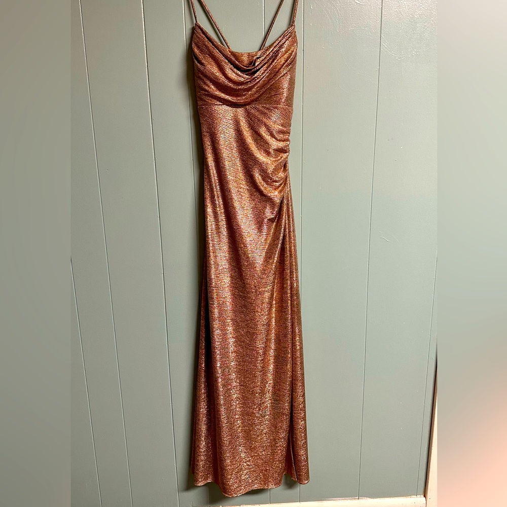 Very sexy shimming gold dress. Slit on the left side. Crisscross’s in the back.